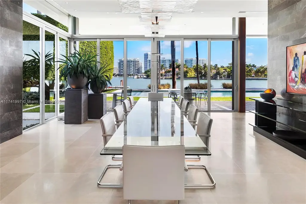 Exterior view of 88 La Gorce Cir, a $88M waterfront luxury estate in Miami Beach, showcasing modern architecture, a Guggenheim-inspired staircase, and breathtaking bay views