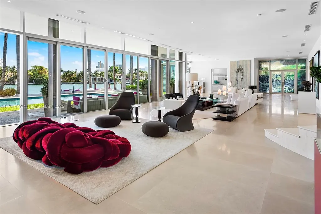 Exterior view of 88 La Gorce Cir, a $88M waterfront luxury estate in Miami Beach, showcasing modern architecture, a Guggenheim-inspired staircase, and breathtaking bay views.