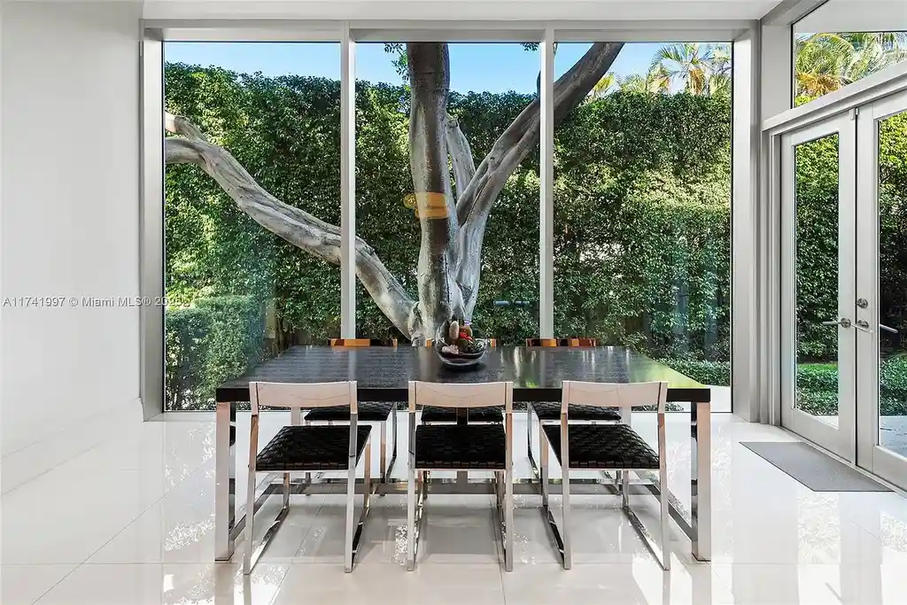 Exterior view of 88 La Gorce Cir, a $88M waterfront luxury estate in Miami Beach, showcasing modern architecture, a Guggenheim-inspired staircase, and breathtaking bay views.