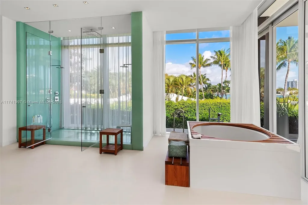 Exterior view of 88 La Gorce Cir, a $88M waterfront luxury estate in Miami Beach, showcasing modern architecture, a Guggenheim-inspired staircase, and breathtaking bay views.