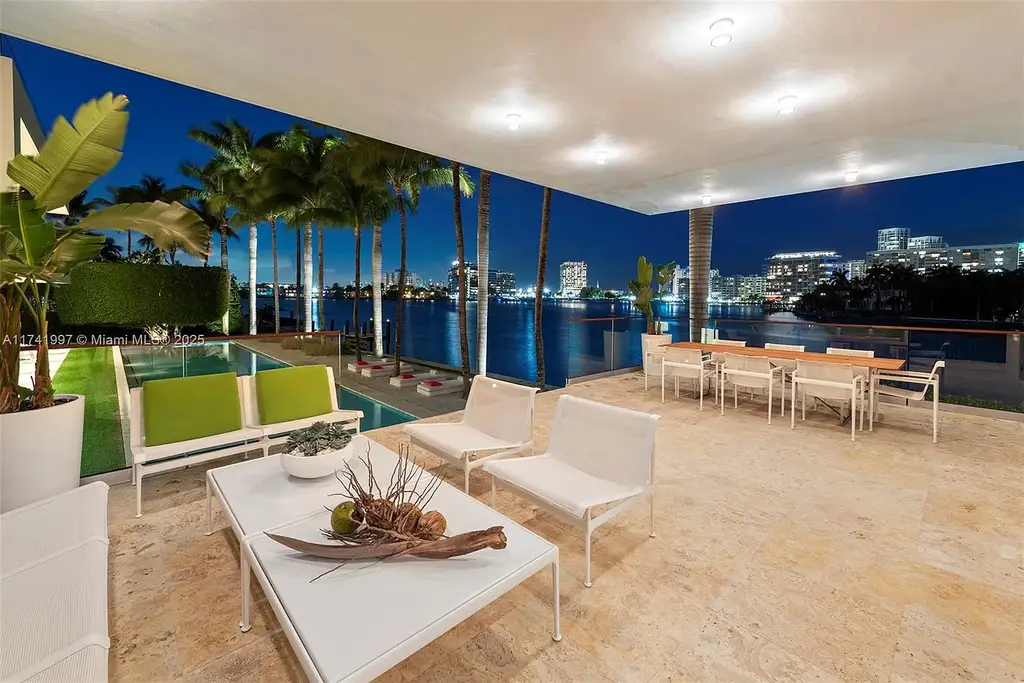 Exterior view of 88 La Gorce Cir, a $88M waterfront luxury estate in Miami Beach, showcasing modern architecture, a Guggenheim-inspired staircase, and breathtaking bay views.