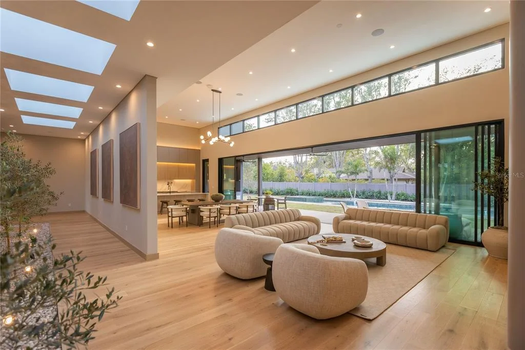 Expansive 65-foot pool at 8968 Bay Cove Ct in Orlando, surrounded by Amazon green limestone tiles and a fully equipped summer kitchen.