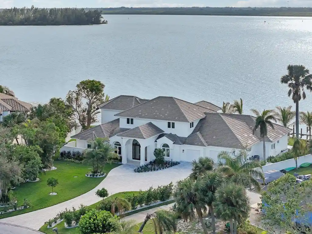 Stunning riverfront view of 526 Point Lane, showcasing the luxurious $6.5M Vero Beach home with expansive outdoor living spaces and panoramic water views, epitomizing Vero Beach real estate elegance.