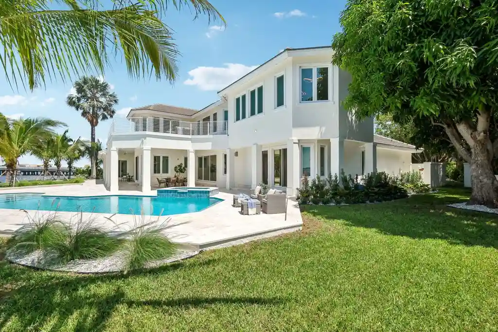 Stunning riverfront view of 526 Point Lane, showcasing the luxurious $6.5M Vero Beach home with expansive outdoor living spaces and panoramic water views, epitomizing Vero Beach real estate elegance.