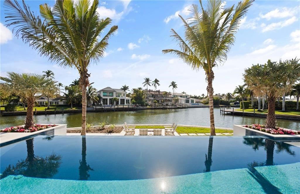 Discover the ultimate waterfront lifestyle in this exquisite Aqualane Shores estate. Set on a .37-acre corner lot with 225 feet of water frontage and coveted southwest rear exposure for breathtaking sunsets and Gulf access, this 6,603 square feet masterpiece (built in 2025) offers 5 bedrooms, 7 baths, and luxurious details throughout.