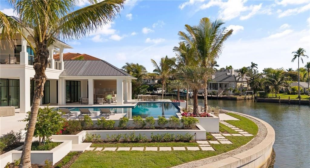 Discover the ultimate waterfront lifestyle in this exquisite Aqualane Shores estate. Set on a .37-acre corner lot with 225 feet of water frontage and coveted southwest rear exposure for breathtaking sunsets and Gulf access, this 6,603 square feet masterpiece (built in 2025) offers 5 bedrooms, 7 baths, and luxurious details throughout.