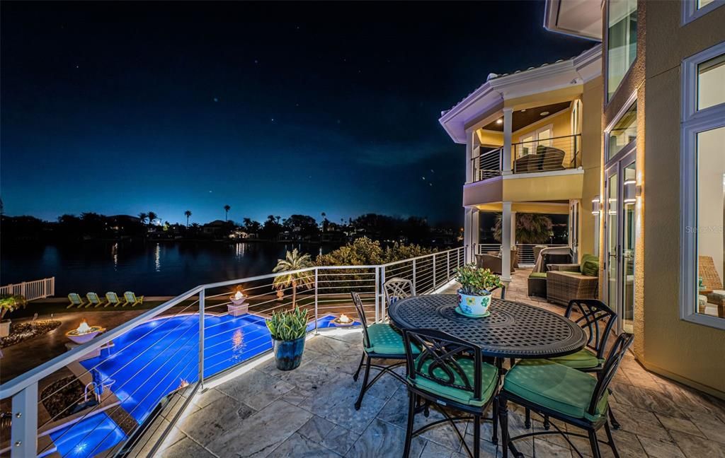 Built in 2018, this smart-home features soaring ceilings, sleek contemporary finishes, and breathtaking water views. The gourmet kitchen boasts quartz countertops, custom cabinetry, a Bosch cooking center, and a butler’s pantry.