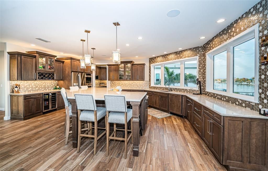 Built in 2018, this smart-home features soaring ceilings, sleek contemporary finishes, and breathtaking water views. The gourmet kitchen boasts quartz countertops, custom cabinetry, a Bosch cooking center, and a butler’s pantry.