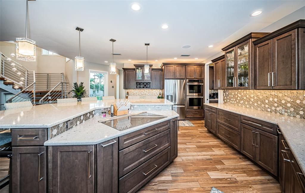 Built in 2018, this smart-home features soaring ceilings, sleek contemporary finishes, and breathtaking water views. The gourmet kitchen boasts quartz countertops, custom cabinetry, a Bosch cooking center, and a butler’s pantry.