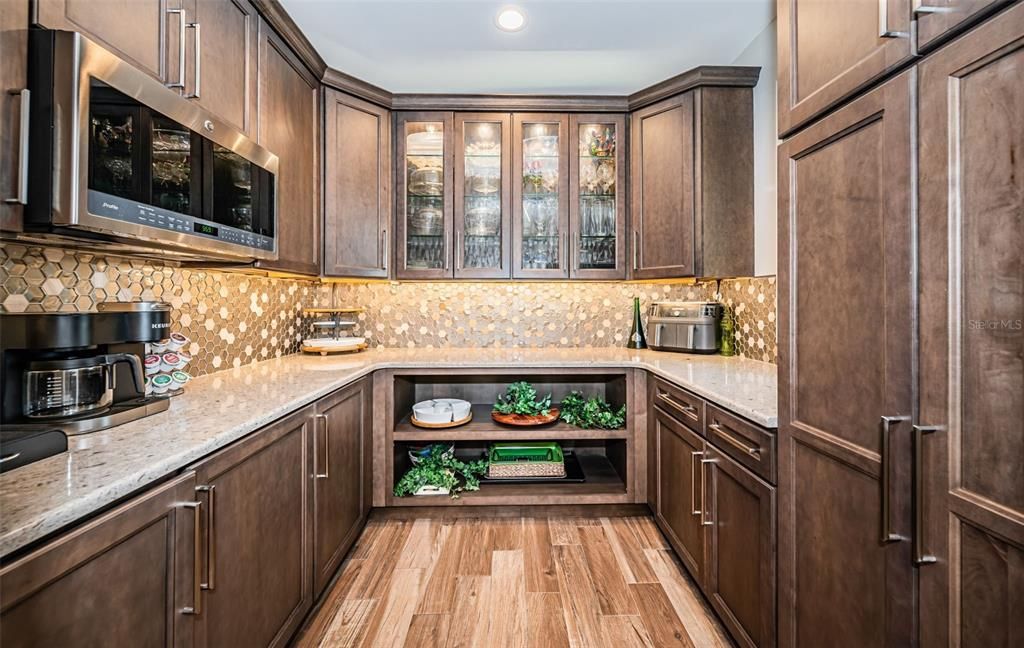 Built in 2018, this smart-home features soaring ceilings, sleek contemporary finishes, and breathtaking water views. The gourmet kitchen boasts quartz countertops, custom cabinetry, a Bosch cooking center, and a butler’s pantry.