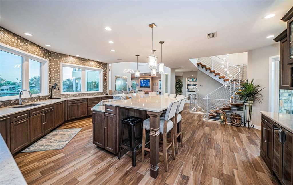 Built in 2018, this smart-home features soaring ceilings, sleek contemporary finishes, and breathtaking water views. The gourmet kitchen boasts quartz countertops, custom cabinetry, a Bosch cooking center, and a butler’s pantry.