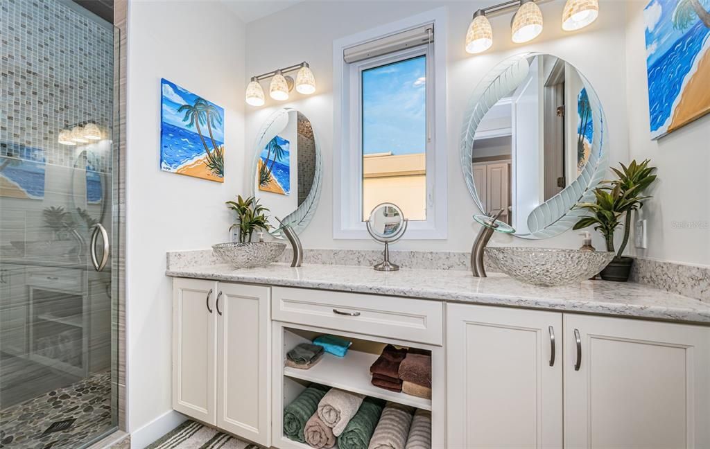 Built in 2018, this smart-home features soaring ceilings, sleek contemporary finishes, and breathtaking water views. The gourmet kitchen boasts quartz countertops, custom cabinetry, a Bosch cooking center, and a butler’s pantry.