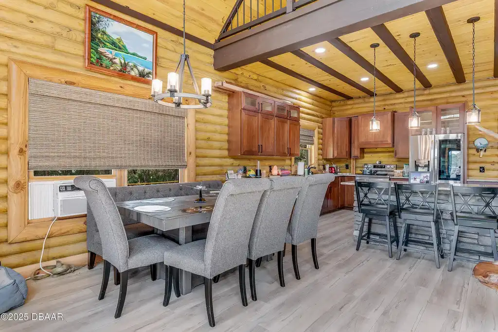 Stunning log cabin estate at 1100 Tallacoe Trl, New Smyrna Beach – a $3.8M rustic retreat with wrap-around porch and expansive countryside views.