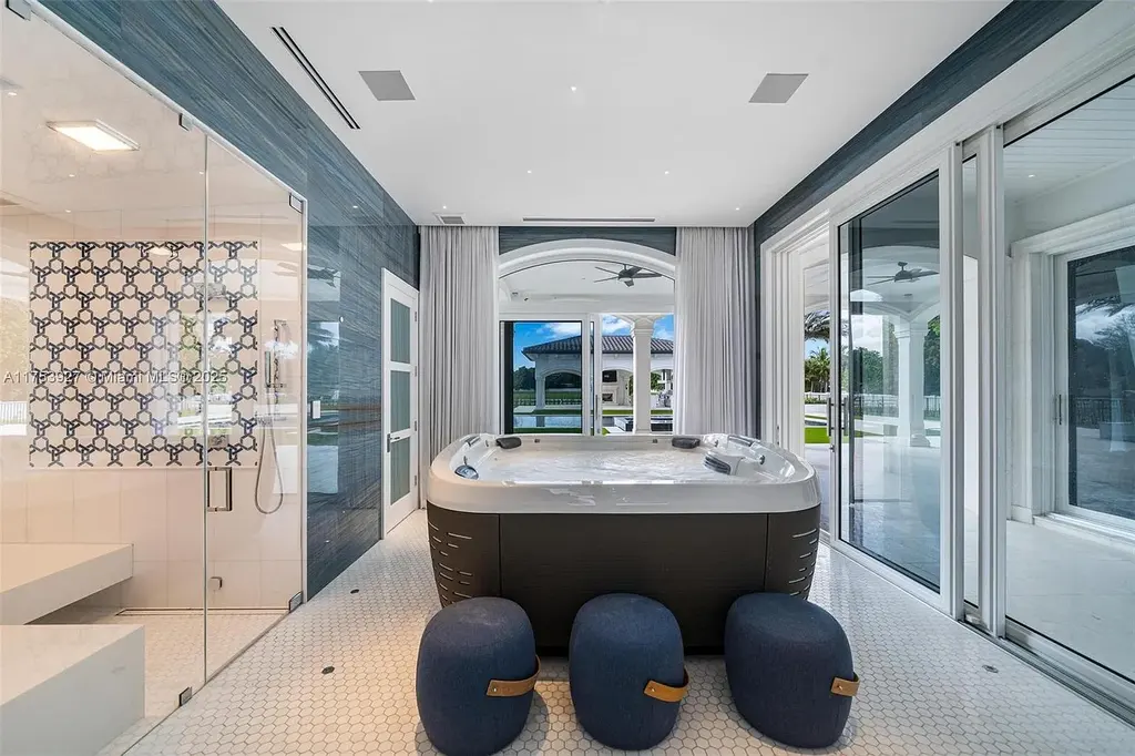 Grand entrance of the $32M estate at 14851 SW 21st St, showcasing synchronized fountains, landscaped gardens, and a resort-style pool house.