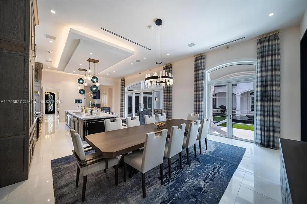 Grand entrance of the $32M estate at 14851 SW 21st St, showcasing synchronized fountains, landscaped gardens, and a resort-style pool house.