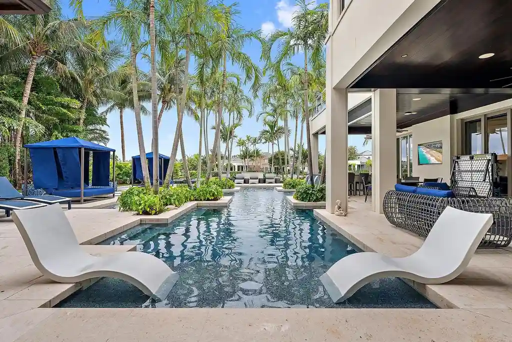 Stunning waterfront estate at 177 Commodore Drive, Jupiter, featuring a resort-style pool, private dock, and luxurious outdoor living spaces.