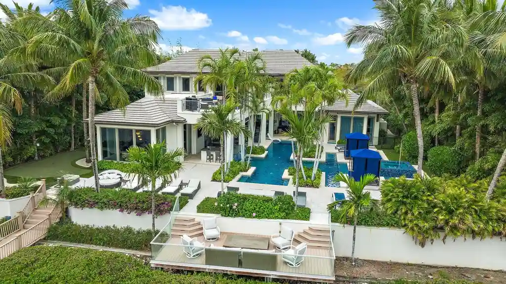 Stunning waterfront estate at 177 Commodore Drive, Jupiter, featuring a resort-style pool, private dock, and luxurious outdoor living spaces.