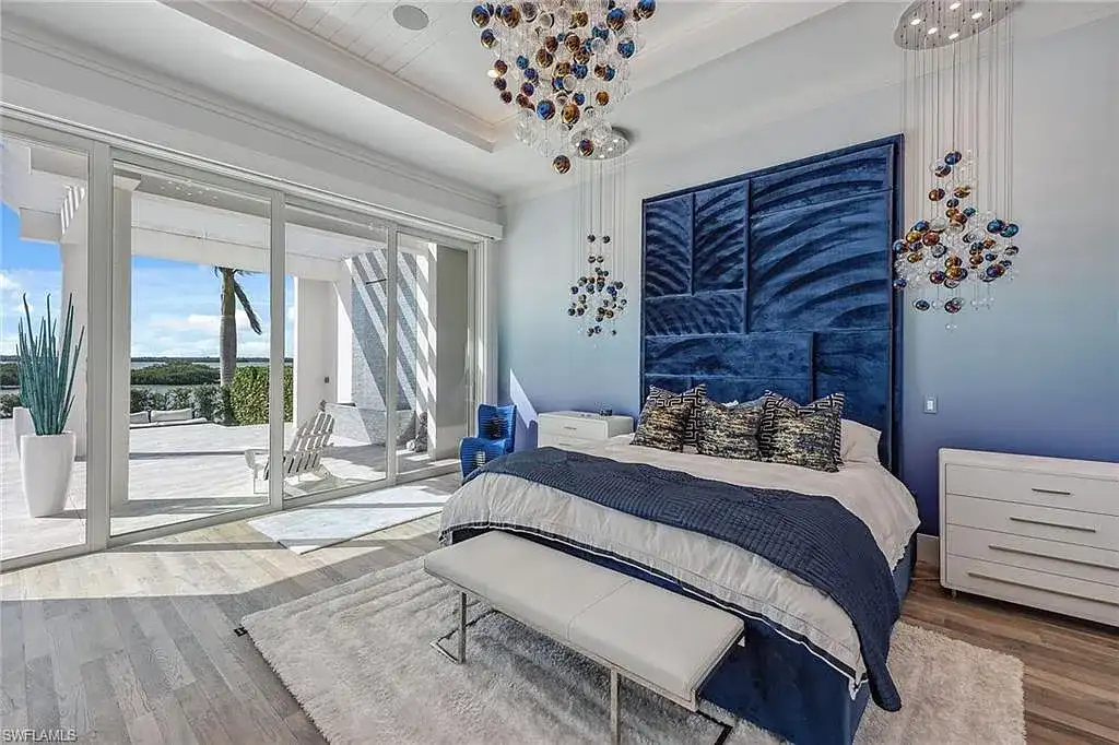 Stunning waterfront estate at 1829 S Inlet Dr, Marco Island, featuring a contemporary coastal design with panoramic Gulf views and lush tropical landscaping.