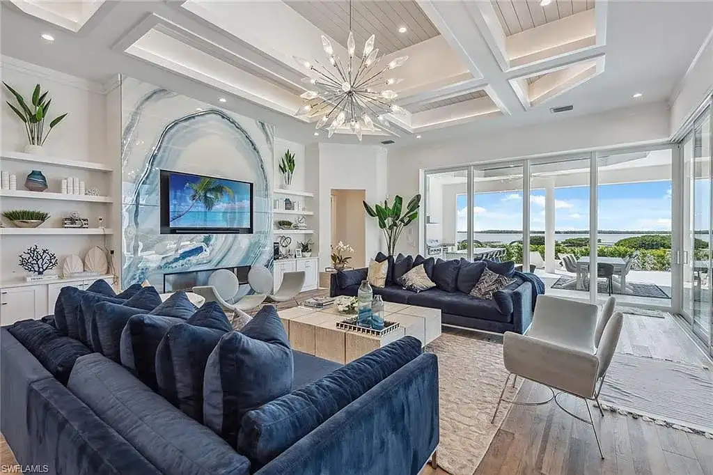 Stunning waterfront estate at 1829 S Inlet Dr, Marco Island, featuring a contemporary coastal design with panoramic Gulf views and lush tropical landscaping.