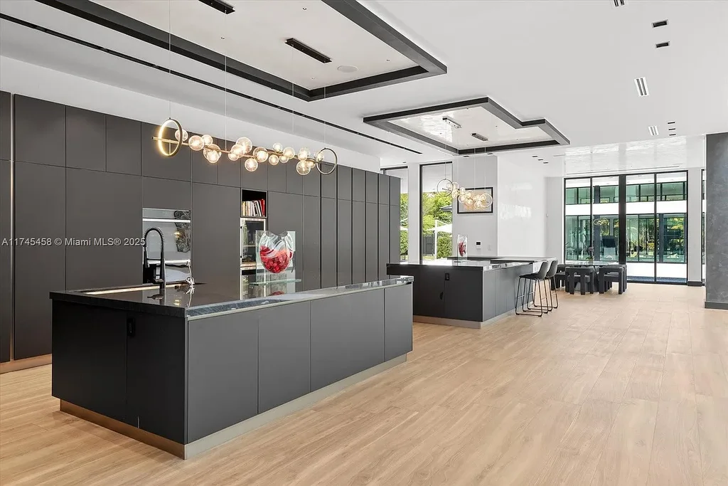 Spacious open-plan living room in 6555 SW 102nd St, featuring double-height ceilings, elegant marble floors, and floor-to-ceiling windows with natural light.