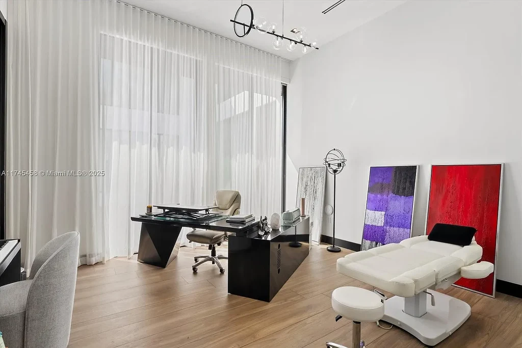 Spacious open-plan living room in 6555 SW 102nd St, featuring double-height ceilings, elegant marble floors, and floor-to-ceiling windows with natural light.