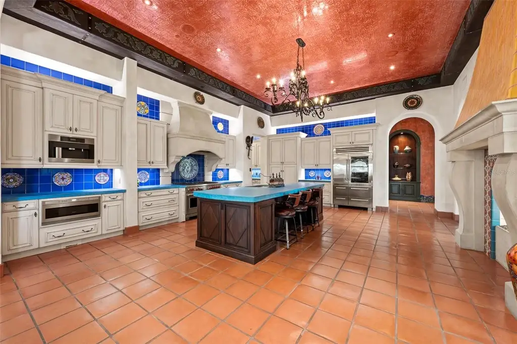 Luxury lakefront estate at 11865 Fort King Hwy in Thonotosassa, Florida, featuring Mediterranean architecture, private dock, Oval Office replica, and tiered pool.