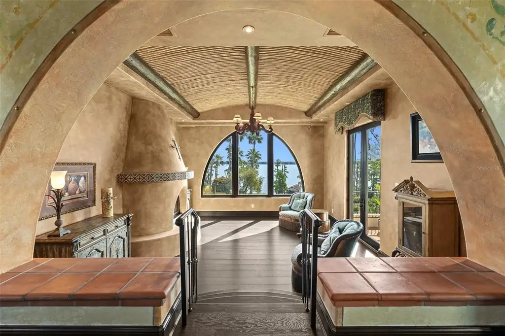 Luxury lakefront estate at 11865 Fort King Hwy in Thonotosassa, Florida, featuring Mediterranean architecture, private dock, Oval Office replica, and tiered pool.