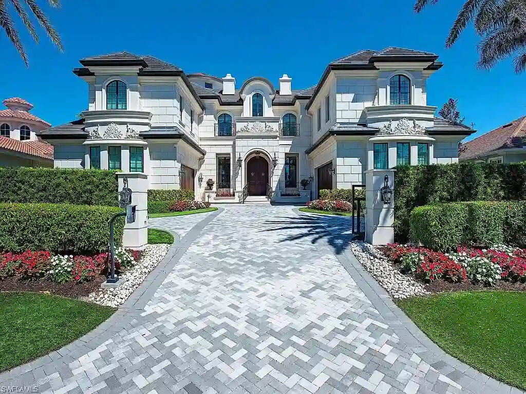Luxury waterfront estate at 233 Mermaids Bight, featuring panoramic bay views, private dock, and elegant design in Park Shore, Naples.