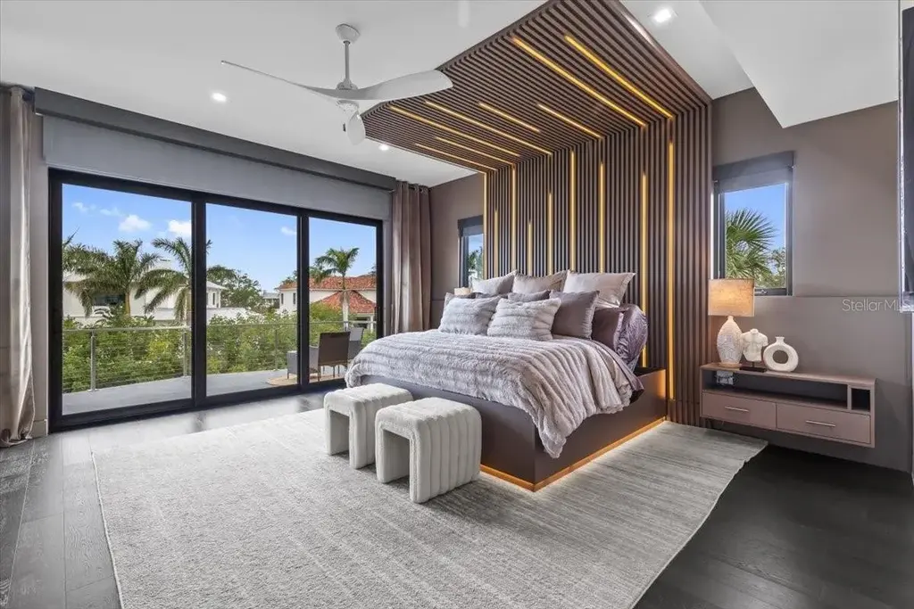 Luxury waterfront estate at 5131 W Neptune Way, Tampa featuring modern architecture, private dock, saltwater pool, rooftop terrace, and smart home technology
