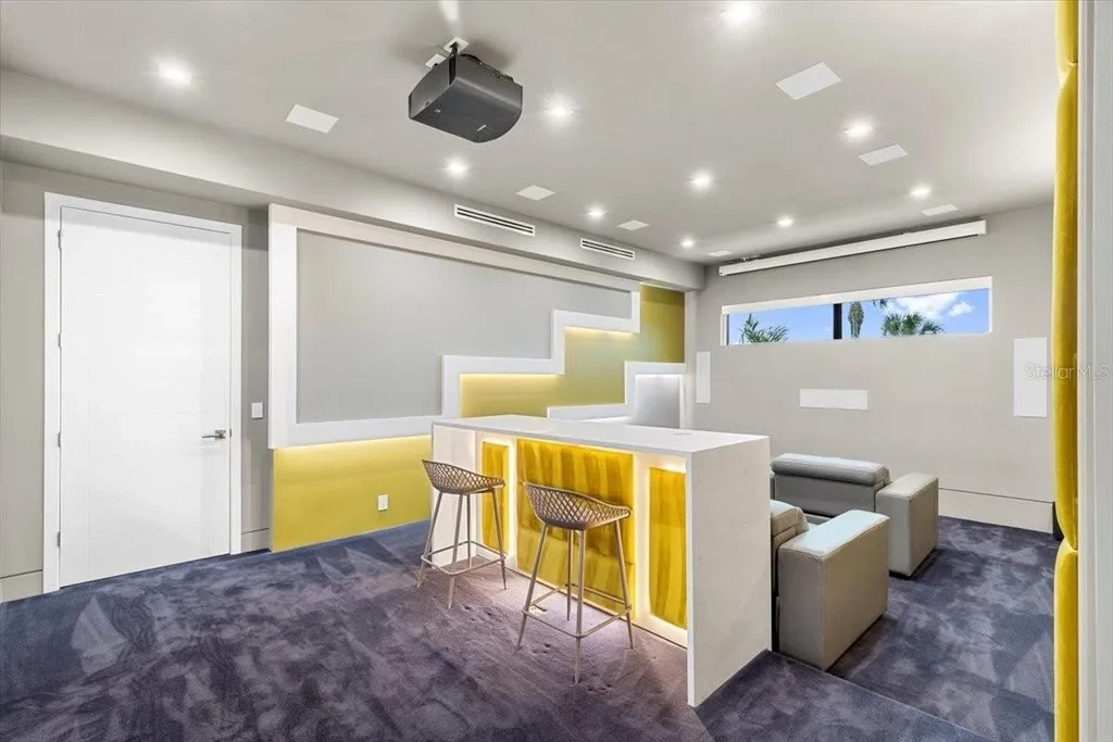 Luxury waterfront estate at 5131 W Neptune Way, Tampa featuring modern architecture, private dock, saltwater pool, rooftop terrace, and smart home technology