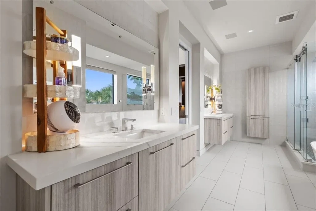Luxury waterfront estate at 5131 W Neptune Way, Tampa featuring modern architecture, private dock, saltwater pool, rooftop terrace, and smart home technology