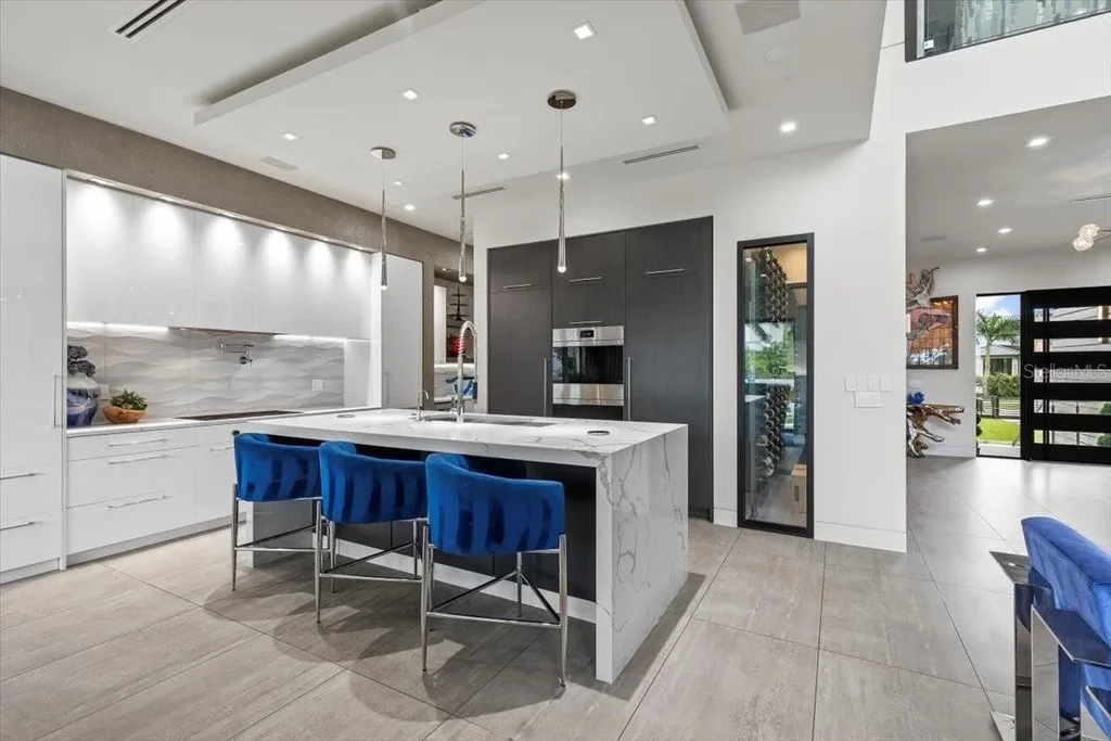 Luxury waterfront estate at 5131 W Neptune Way, Tampa featuring modern architecture, private dock, saltwater pool, rooftop terrace, and smart home technology