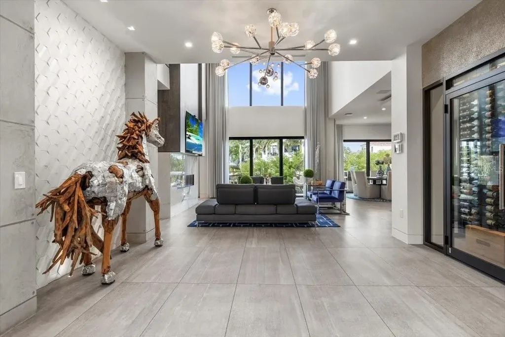 Luxury waterfront estate at 5131 W Neptune Way, Tampa featuring modern architecture, private dock, saltwater pool, rooftop terrace, and smart home technology