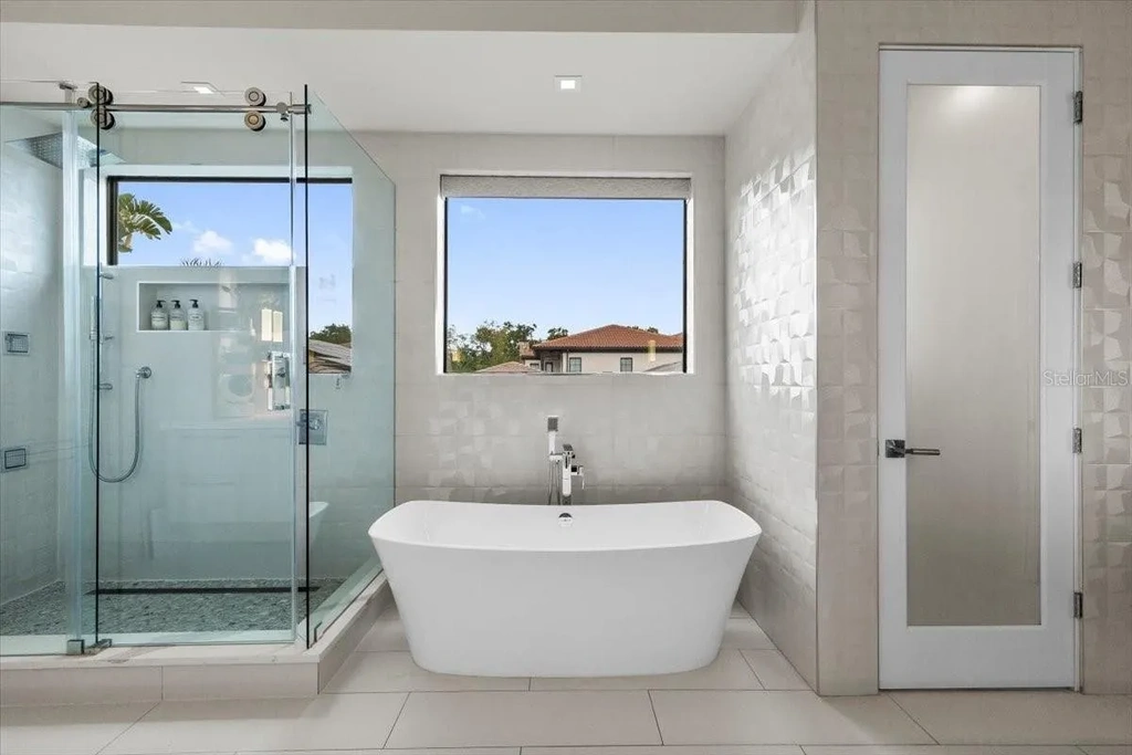 Luxury waterfront estate at 5131 W Neptune Way, Tampa featuring modern architecture, private dock, saltwater pool, rooftop terrace, and smart home technology