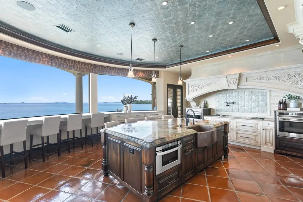 Luxury Mediterranean waterfront estate at 100 Sands Point Dr in Tierra Verde, FL, featuring private dock, saltwater pool, guest casita, and panoramic bay views