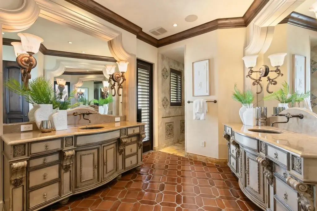 Luxury Mediterranean waterfront estate at 100 Sands Point Dr in Tierra Verde, FL, featuring private dock, saltwater pool, guest casita, and panoramic bay views