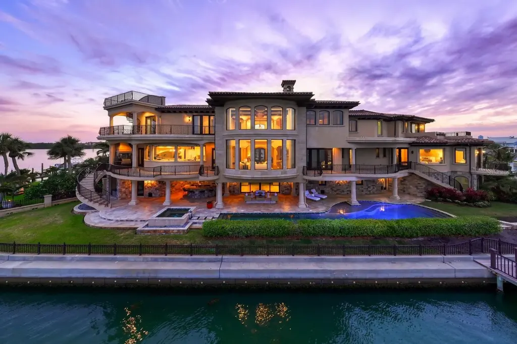 Luxury Mediterranean waterfront estate at 100 Sands Point Dr in Tierra Verde, FL, featuring private dock, saltwater pool, guest casita, and panoramic bay views