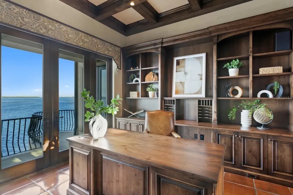 Luxury Mediterranean waterfront estate at 100 Sands Point Dr in Tierra Verde, FL, featuring private dock, saltwater pool, guest casita, and panoramic bay views