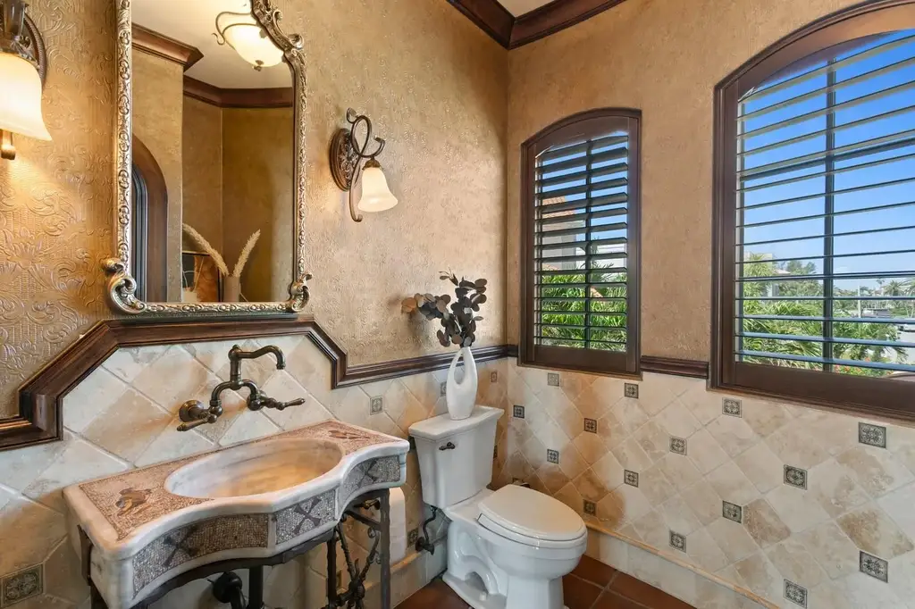 Luxury Mediterranean waterfront estate at 100 Sands Point Dr in Tierra Verde, FL, featuring private dock, saltwater pool, guest casita, and panoramic bay views
