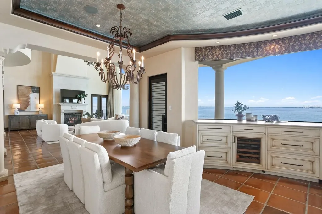 Luxury Mediterranean waterfront estate at 100 Sands Point Dr in Tierra Verde, FL, featuring private dock, saltwater pool, guest casita, and panoramic bay views