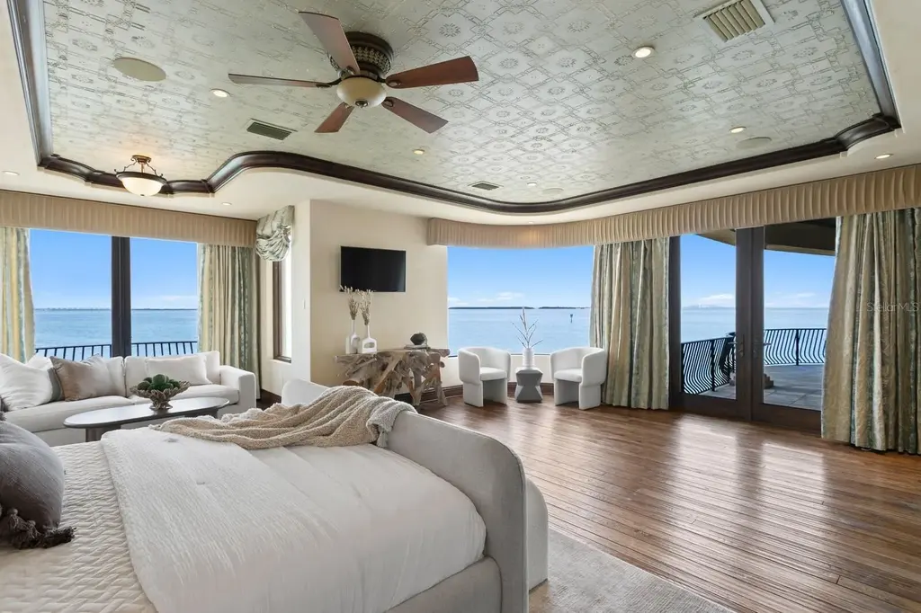 Luxury Mediterranean waterfront estate at 100 Sands Point Dr in Tierra Verde, FL, featuring private dock, saltwater pool, guest casita, and panoramic bay views