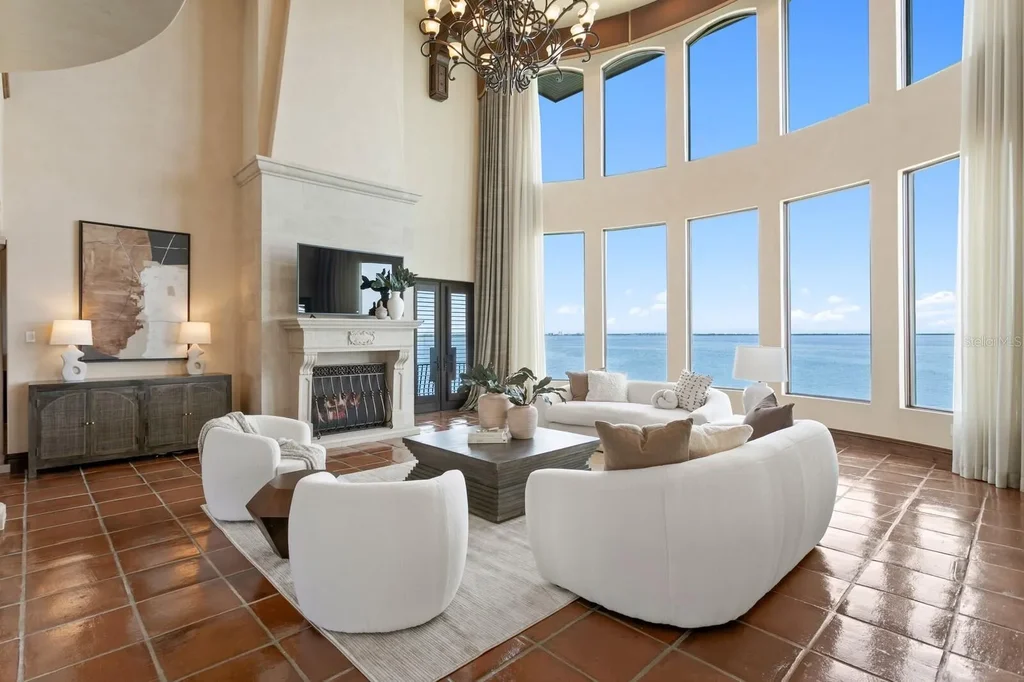 Luxury Mediterranean waterfront estate at 100 Sands Point Dr in Tierra Verde, FL, featuring private dock, saltwater pool, guest casita, and panoramic bay views