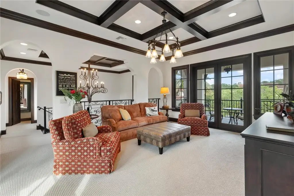 Front view of 10138 Enchanted Oak Dr showcasing Mediterranean architecture and lush landscaping in Orlando Real Estate.