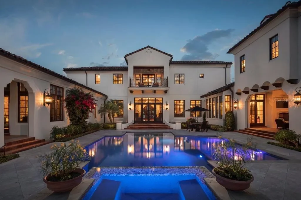 Front view of 10138 Enchanted Oak Dr showcasing Mediterranean architecture and lush landscaping in Orlando Real Estate.