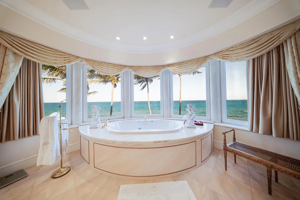 Italian-inspired luxury mansion at 1280 S Ocean Boulevard in Manalapan with waterfront frontage and lush landscaping