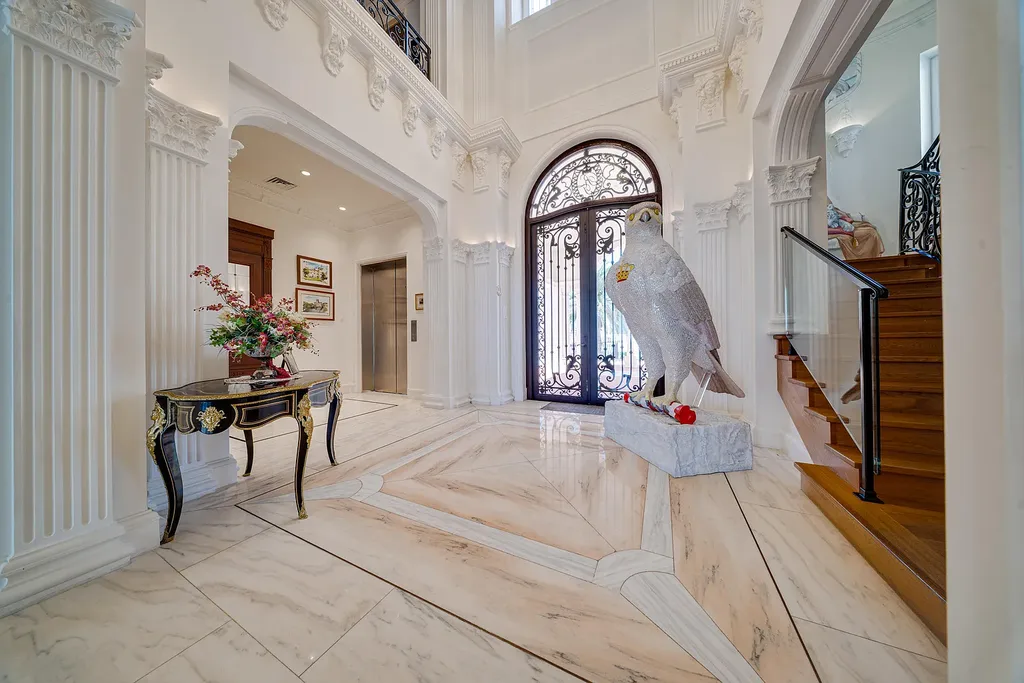 Italian-inspired luxury mansion at 1280 S Ocean Boulevard in Manalapan with waterfront frontage and lush landscaping
