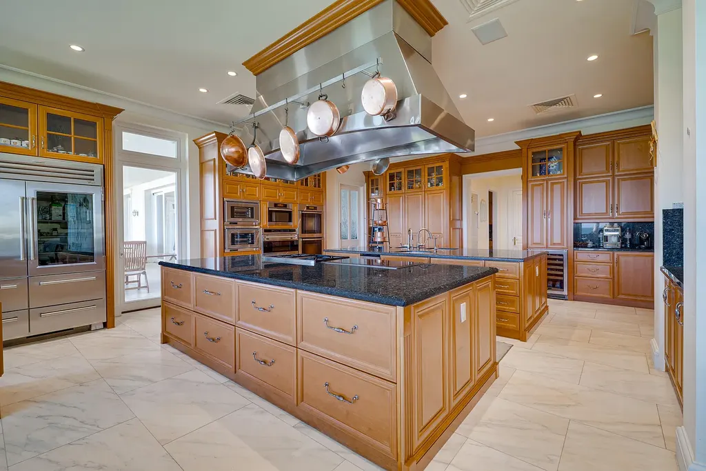 Italian-inspired luxury mansion at 1280 S Ocean Boulevard in Manalapan with waterfront frontage and lush landscaping