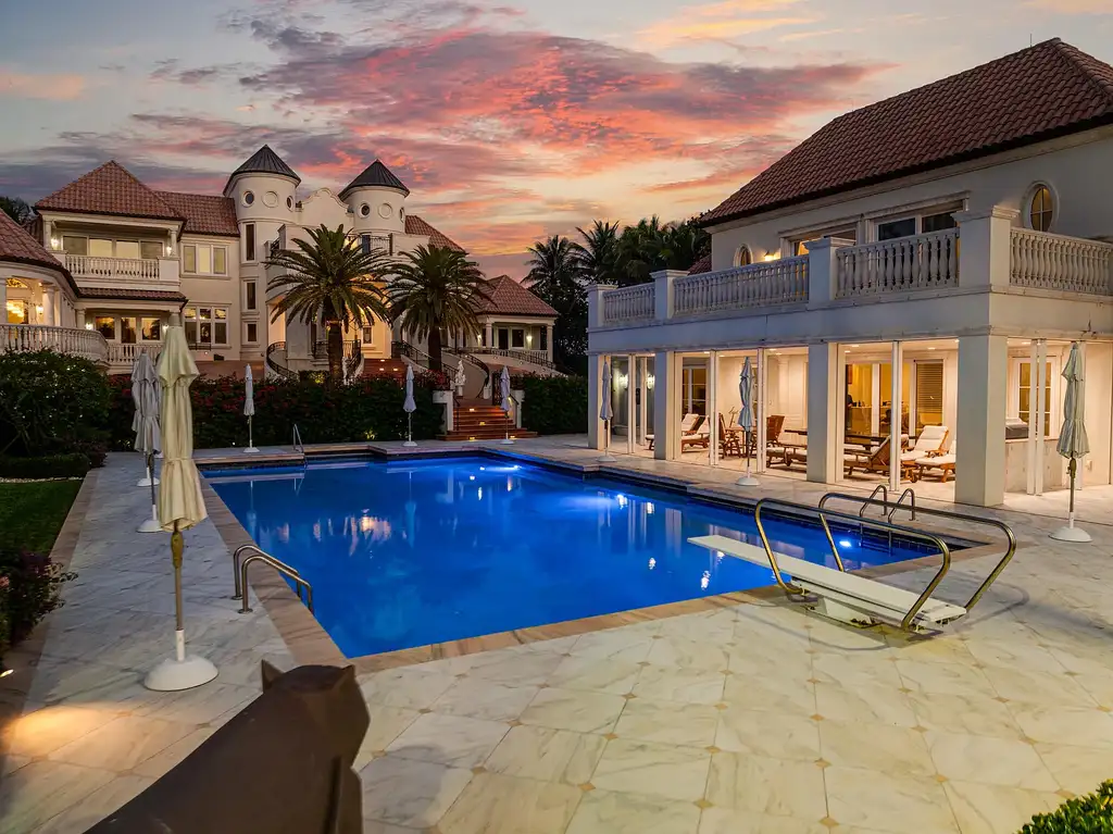 Italian-inspired luxury mansion at 1280 S Ocean Boulevard in Manalapan with waterfront frontage and lush landscaping