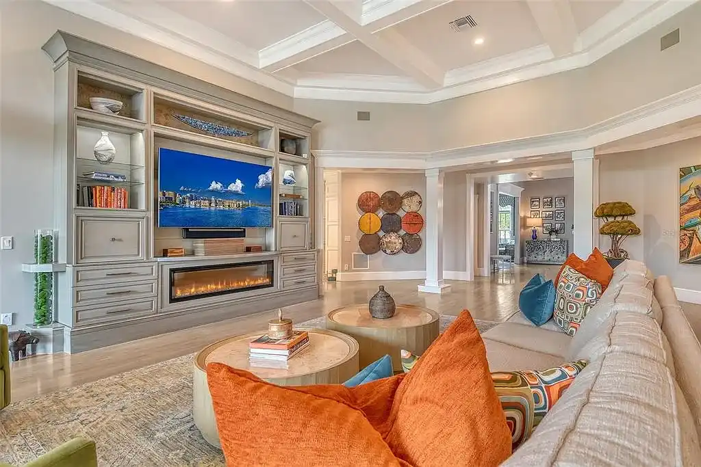 Elegant Georgian colonial waterfront estate at 1541 Bay Point Dr in Sarasota, FL featuring private dock, saltwater pool, theater room, and lush tropical landscaping.