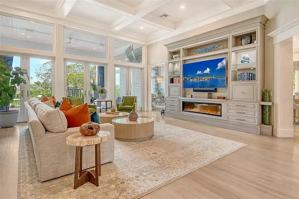 Elegant Georgian colonial waterfront estate at 1541 Bay Point Dr in Sarasota, FL featuring private dock, saltwater pool, theater room, and lush tropical landscaping.